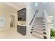 Elegant hallway with stairs, wine bar, and view into the bedroom at 5822 Title Row Dr, Bradenton, FL 34210