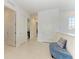 Bright hallway with white walls, white doors, and a blue tufted bench at 5822 Title Row Dr, Bradenton, FL 34210