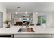 Bright kitchen with white countertops and stainless steel sink overlooking the living room and outdoor patio at 5822 Title Row Dr, Bradenton, FL 34210