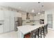 Bright kitchen with modern appliances, white cabinetry, and an ample island with bar seating at 5822 Title Row Dr, Bradenton, FL 34210