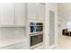 Kitchen featuring built-in stainless steel ovens and pantry at 5822 Title Row Dr, Bradenton, FL 34210