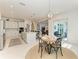 Open-concept kitchen and dining area with plenty of room for entertaining and a view of the backyard at 5822 Title Row Dr, Bradenton, FL 34210