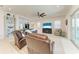 Bright, open living room with comfortable seating, ceiling fan, and large-screen TV at 5822 Title Row Dr, Bradenton, FL 34210