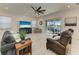Cozy living room provides comfortable seating and large sliding glass doors that let in ample natural light and picturesque lake views at 5822 Title Row Dr, Bradenton, FL 34210
