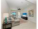 Bright living room features a comfortable sectional sofa, ceiling fan, and a large TV at 5822 Title Row Dr, Bradenton, FL 34210