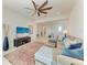 Bright living room features a comfortable sectional sofa, ceiling fan, and neutral decor at 5822 Title Row Dr, Bradenton, FL 34210