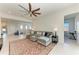 Bright living room features a comfortable sectional sofa, ceiling fan, and neutral decor at 5822 Title Row Dr, Bradenton, FL 34210
