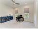 Large home office featuring neutral walls, two windows, desk and bookcase at 5822 Title Row Dr, Bradenton, FL 34210