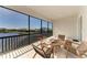Screened-in porch featuring a table and four chairs, overlooking a tranquil lake at 5822 Title Row Dr, Bradenton, FL 34210