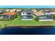 Aerial view of a two-story home featuring a screened-in pool, surrounded by well-manicured lawn and a picturesque lake at 5822 Title Row Dr, Bradenton, FL 34210