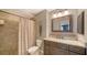 Well-lit bathroom featuring shower, vanity, framed mirror, and a tiled floor at 6033 34Th W St # 35, Bradenton, FL 34210