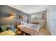 Cozy bedroom with ample natural light, hardwood floors, and a comfortable bed at 6033 34Th W St # 35, Bradenton, FL 34210