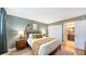 Stylish bedroom featuring a comfortable bed, wood floors, and an attached bathroom at 6033 34Th W St # 35, Bradenton, FL 34210