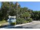 Sign for Harbor Pines Condominiums surrounded by lush landscaping and trees at 6033 34Th W St # 35, Bradenton, FL 34210