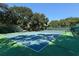 Community tennis court surrounded by trees and lush landscaping at 6033 34Th W St # 35, Bradenton, FL 34210