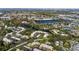 Expansive aerial view of condo community with mature trees, serene lakes, and convenient parking at 622 Spring Lakes Blvd, Bradenton, FL 34210