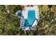 A beautiful aerial view of a community pool with crystal clear water, loungers, and lush landscaping at 622 Spring Lakes Blvd, Bradenton, FL 34210