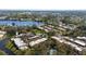 Beautiful aerial view of condos showcasing lush greenery, community pool, and serene lake views at 622 Spring Lakes Blvd, Bradenton, FL 34210