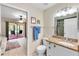 Bright bathroom featuring a granite countertop vanity and easy access to the screened-in patio at 622 Spring Lakes Blvd, Bradenton, FL 34210