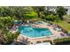 Relaxing pool with crystal clear water, loungers, landscaping and mature trees providing shade at 622 Spring Lakes Blvd, Bradenton, FL 34210