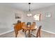 Well-lit dining room with stylish light fixture above the wooden dining table at 622 Spring Lakes Blvd, Bradenton, FL 34210