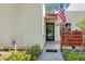 Inviting front entrance featuring a well-maintained walkway, fresh landscaping, and an American flag at 622 Spring Lakes Blvd, Bradenton, FL 34210