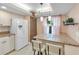 Updated kitchen with granite counters, white cabinets, and breakfast bar seating, perfect for casual dining at 622 Spring Lakes Blvd, Bradenton, FL 34210