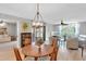 Spacious living area with wood-look flooring, a ceiling fan, and sliding glass doors leading to a tranquil outdoor space at 622 Spring Lakes Blvd, Bradenton, FL 34210