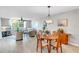 Open-concept living and dining area with neutral walls, ceiling fan, and wood-look flooring, ideal for entertaining at 622 Spring Lakes Blvd, Bradenton, FL 34210