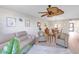 Cozy living room with ceiling fan and seating area opening up to the dining room at 622 Spring Lakes Blvd, Bradenton, FL 34210