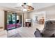 Comfortable living room with ceiling fan and sliding doors to the screened-in patio at 622 Spring Lakes Blvd, Bradenton, FL 34210