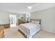 Comfortable bedroom featuring a patterned quilt, chest of drawers, and ensuite bathroom access at 622 Spring Lakes Blvd, Bradenton, FL 34210