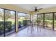 Cozy sunroom features tiled floors and large windows with a view to a verdant landscape at 622 Spring Lakes Blvd, Bradenton, FL 34210