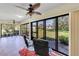 Enclosed sunroom features tile flooring, ceiling fan and large windows with a view to the backyard at 622 Spring Lakes Blvd, Bradenton, FL 34210