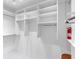 This large walk-in closet has white shelving units, hanging rods, and ample storage space at 622 Spring Lakes Blvd, Bradenton, FL 34210