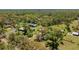 Expansive aerial view of a property surrounded by lush greenery and multiple structures at 6510 13Th E Ave, Bradenton, FL 34208