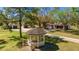 A picturesque angle of this charming home with a covered gazebo and 3 car garages at 6510 13Th E Ave, Bradenton, FL 34208