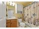 Nautical themed bathroom features a seashell shower curtain and wood vanity at 6519 Grand Estuary Trl # 101, Bradenton, FL 34212