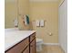 Well-lit bathroom with a vanity, mirror, toilet, and a closet for plenty of storage at 6519 Grand Estuary Trl # 101, Bradenton, FL 34212