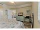 Bright bedroom featuring a dresser with a TV and a glimpse of the living room at 6519 Grand Estuary Trl # 101, Bradenton, FL 34212