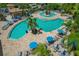 Aerial view of a multi-tiered community pool featuring ample seating and lush landscaping at 6519 Grand Estuary Trl # 101, Bradenton, FL 34212