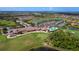 Aerial shot displays the community amenities, including the golf course, pool, clubhouse, waterways, and tennis courts at 6519 Grand Estuary Trl # 101, Bradenton, FL 34212