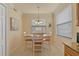 Bright dining area with a decorative light fixture and tile floors provides comfortable seating for four people at 6519 Grand Estuary Trl # 101, Bradenton, FL 34212