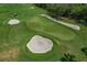 Aerial view of a golf course featuring sand traps, a golf cart, and manicured greens at 6519 Grand Estuary Trl # 101, Bradenton, FL 34212