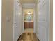 Hallway leading to a bathroom, featuring tiled floors and storage closets on each side at 6519 Grand Estuary Trl # 101, Bradenton, FL 34212