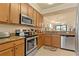 Well-appointed kitchen featuring granite countertops, stainless steel appliances, and an open layout to living area at 6519 Grand Estuary Trl # 101, Bradenton, FL 34212