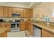 Well-equipped kitchen featuring granite countertops, stainless steel appliances, and ample cabinet space at 6519 Grand Estuary Trl # 101, Bradenton, FL 34212