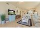 Cozy living room with a TV, stylish decor, and an open view to the modern kitchen at 6519 Grand Estuary Trl # 101, Bradenton, FL 34212