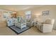Open-concept living area with cozy sofas, coffee table, and seamless flow to the adjacent kitchen space at 6519 Grand Estuary Trl # 101, Bradenton, FL 34212