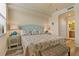 Comfortable main bedroom features a ceiling fan, beach decor, and wood look floors at 6519 Grand Estuary Trl # 101, Bradenton, FL 34212